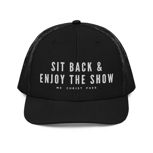 Sit Back & Enjoy The Show by @Mr.Christ0pher Trucker Hat